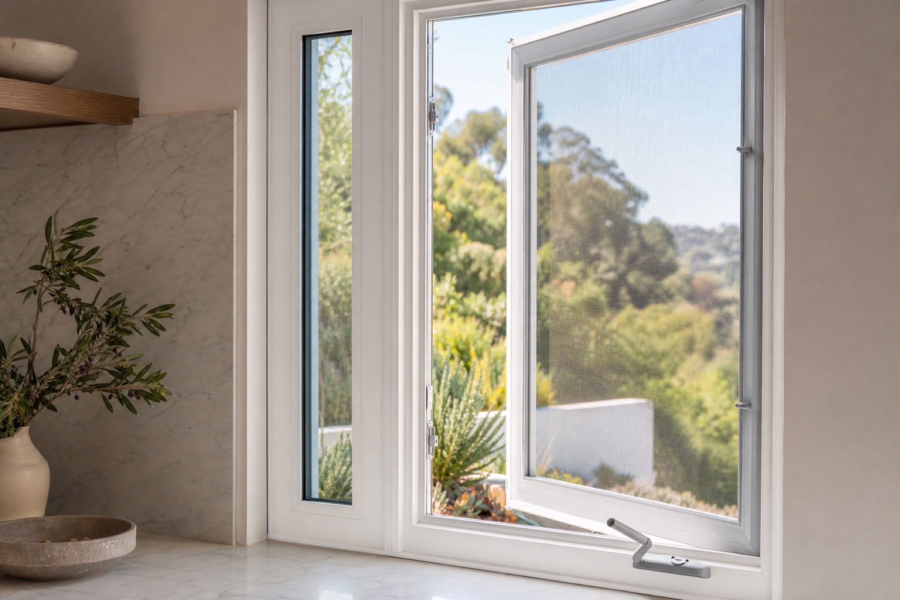 White casement sash opening outward with its crank and screen visible
