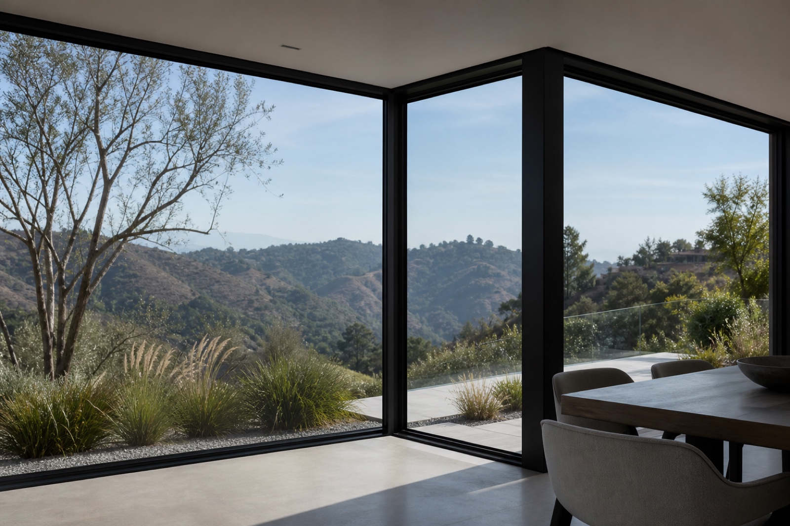 Slim black aluminum corner windows overlooking Los Angeles foothills