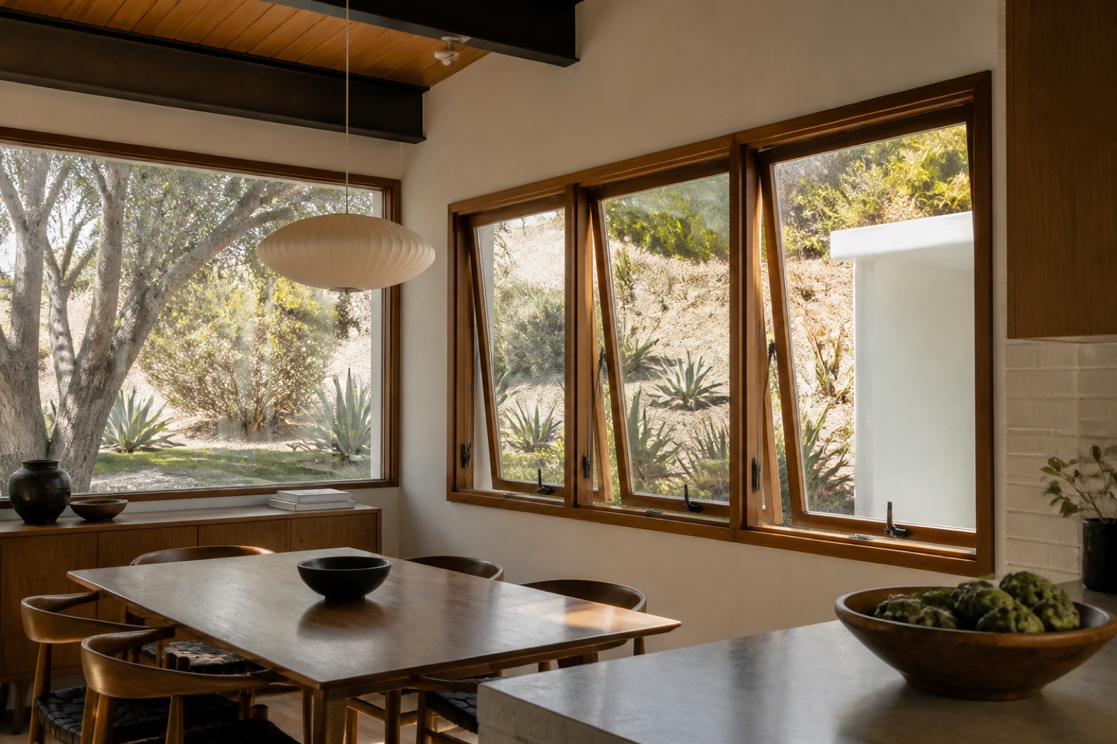 Warm wood-framed windows in a refined Los Angeles dining room