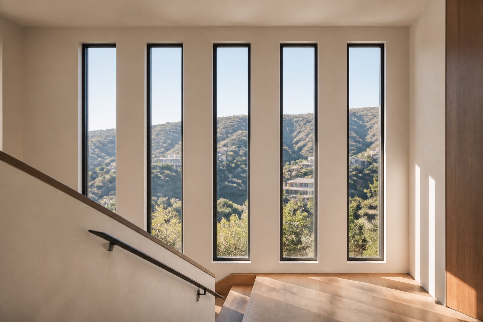 Tall fiberglass windows forming a precise rhythm above a modern stair